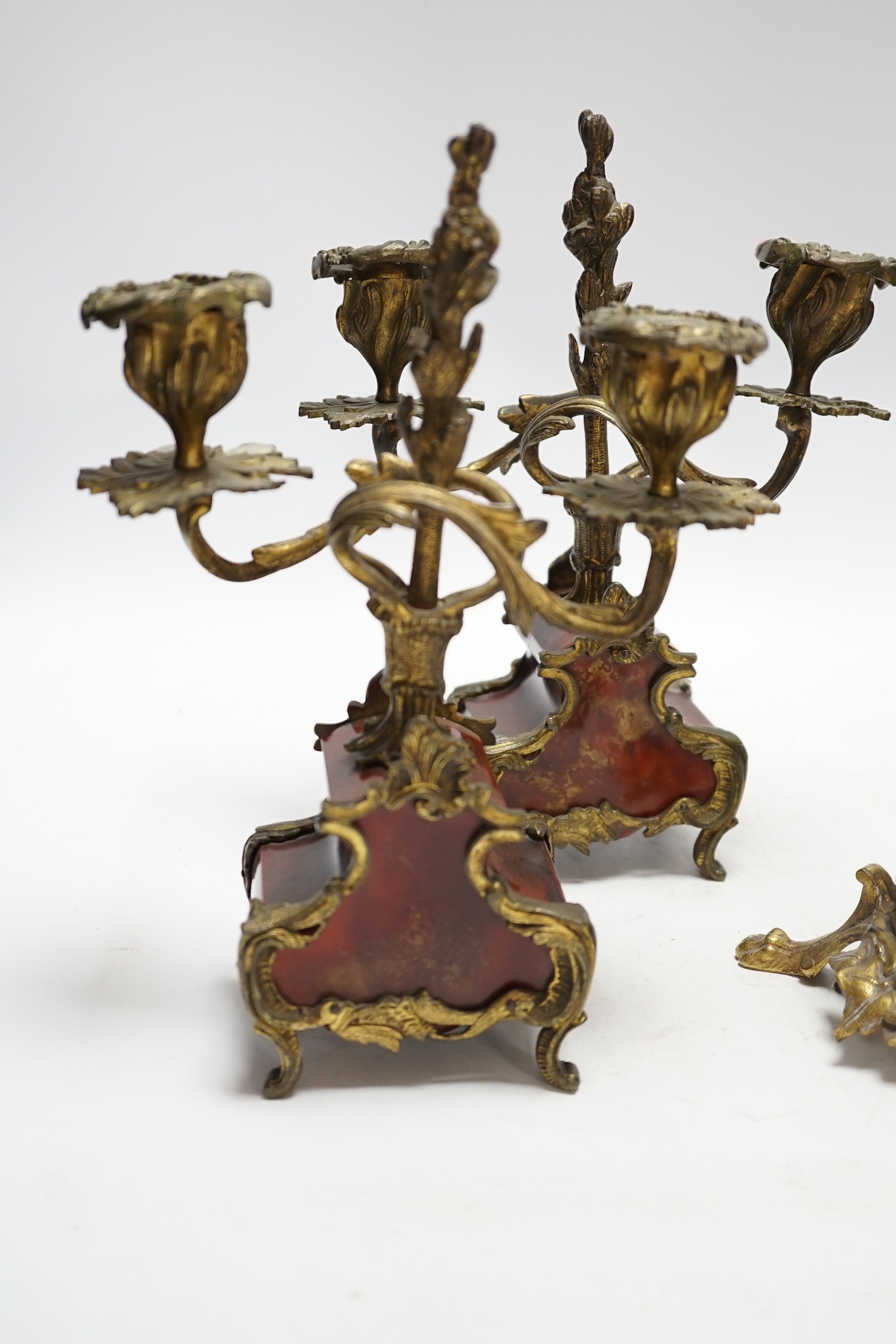 A pair of Victorian bronze and gilt metal figural candlesticks and a pair of tortoiseshell and gilt metal candelabra, largest 24cm high